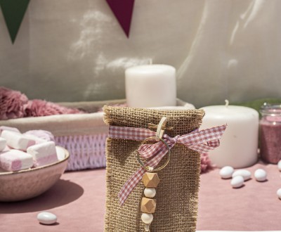 Μπομπονιέρα με γιούτα σε σχήμα φάκελο διακοσμημένη με μεταλλικό στοιχείο μάτι σε μπρελόκ και διάφορες χάντρες